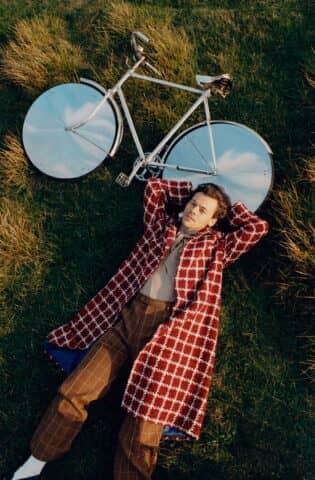 Gridded overcoat, pussy-bow shirt, and checked pants, all by Gucci.